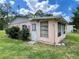 Rear exterior view, showcasing the home's quaint design and landscaping at 6045 Colony Cir, Weeki Wachee, FL 34607