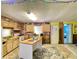 Kitchen with wooden cabinets, brick wall, kitchen island and a view to an adjacent room at 6045 Colony Cir, Weeki Wachee, FL 34607