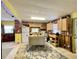 Open kitchen concept with brick walls, wooden cabinets, and a central island at 6045 Colony Cir, Weeki Wachee, FL 34607