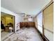 Bright living room features large windows with blinds, ceiling fan, and adjoins a bedroom and a kitchen at 6045 Colony Cir, Weeki Wachee, FL 34607