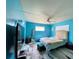 Brightly painted bedroom features a ceiling fan, a window and a television at 6045 Colony Cir, Weeki Wachee, FL 34607