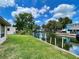 Waterfront property with dock, canal, seawall, and lush green lawn offers serene outdoor living at 6045 Colony Cir, Weeki Wachee, FL 34607