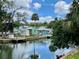 Scenic canal-front homes with personal boat docks, lush trees, and beautiful cloud reflections at 6045 Colony Cir, Weeki Wachee, FL 34607