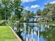 Scenic waterfront view of a home along the canal, showcasing lush landscaping and calm water at 6045 Colony Cir, Weeki Wachee, FL 34607