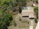 Aerial view of the property with the screened-in pool, home, and driveway at 6516 Hillview Rd, Spring Hill, FL 34606