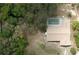 An aerial view of the property, revealing the home, screened-in pool, and surrounding landscape at 6516 Hillview Rd, Spring Hill, FL 34606