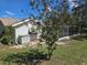 The home's backyard featuring a view of the screened-in lanai and vinyl storage shed at 6516 Hillview Rd, Spring Hill, FL 34606