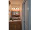 Well-lit bathroom with wooden vanity, medicine cabinet, and ample counter space at 6516 Hillview Rd, Spring Hill, FL 34606
