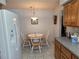 Cozy breakfast nook with round table, three chairs, and direct view of the backyard at 6516 Hillview Rd, Spring Hill, FL 34606