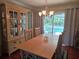 Dining room featuring a dining table, four chairs, cabinet, light fixture, and sliding door to pool area at 6516 Hillview Rd, Spring Hill, FL 34606