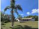 Single-story home boasts a brick facade, attached garage, and a well-manicured lawn with mature trees at 6516 Hillview Rd, Spring Hill, FL 34606