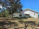 This shows the home's exterior with its screened in patio, backyard and exterior features at 6516 Hillview Rd, Spring Hill, FL 34606