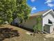 A view of the home's exterior, featuring a large tree in the yard at 6516 Hillview Rd, Spring Hill, FL 34606