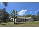 Single-story home boasts a brick facade, attached garage, and a well-manicured lawn with mature trees at 6516 Hillview Rd, Spring Hill, FL 34606