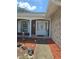 Close up of front door showing a brick facade, well-kept lawn, and a covered entrance way at 6516 Hillview Rd, Spring Hill, FL 34606
