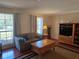 Comfortable living area with hardwood floors, plush sofa, media center, and a large window at 6516 Hillview Rd, Spring Hill, FL 34606