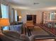 Comfortable living area with hardwood floors, plush sofa, media center, and a large window at 6516 Hillview Rd, Spring Hill, FL 34606