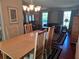 Open-concept living room and dining area with hardwood floors, neutral paint, dining set, and large windows at 6516 Hillview Rd, Spring Hill, FL 34606