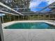 Relaxing in-ground pool with screen enclosure and patio area for outdoor enjoyment and privacy at 6516 Hillview Rd, Spring Hill, FL 34606