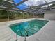 Relaxing in-ground pool with screen enclosure and patio area for outdoor enjoyment and privacy at 6516 Hillview Rd, Spring Hill, FL 34606