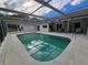 Relaxing in-ground pool with screen enclosure and patio area for outdoor enjoyment and privacy at 6516 Hillview Rd, Spring Hill, FL 34606