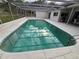 In-ground swimming pool featuring a screened enclosure, patio area, and convenient access stairs at 6516 Hillview Rd, Spring Hill, FL 34606