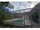 Enclosed pool area with glass and metal frame, perfect for year-round swimming and entertaining with ample patio space at 6516 Hillview Rd, Spring Hill, FL 34606