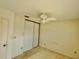 Bedroom showcasing a ceiling fan and closet doors at 6527 Spring Flower Dr # 24, New Port Richey, FL 34653