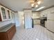 Bright kitchen with tiled floor, ample counter space, and classic cabinetry at 6527 Spring Flower Dr # 24, New Port Richey, FL 34653