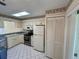 Well-lit kitchen with tiled floor, ample counter space, and classic cabinetry at 6527 Spring Flower Dr # 24, New Port Richey, FL 34653