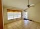 Bright living room featuring tile flooring, a ceiling fan, and access to the outdoor area at 6527 Spring Flower Dr # 24, New Port Richey, FL 34653