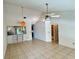 Open living room with tile flooring, vaulted ceilings, and a ceiling fan at 6527 Spring Flower Dr # 24, New Port Richey, FL 34653
