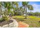 Spacious backyard with lush landscaping, dock access, and serene waterfront views at 6552 River Rd, New Port Richey, FL 34652