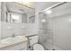 Bathroom featuring tiled shower with glass door, updated vanity, and bright lighting at 6552 River Rd, New Port Richey, FL 34652