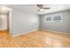 Comfortable bedroom featuring hardwood floors, neutral walls, and a ceiling fan for a serene atmosphere at 6552 River Rd, New Port Richey, FL 34652