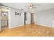 Bedroom with hardwood floors, ceiling fan, closet, and ensuite bathroom at 6552 River Rd, New Port Richey, FL 34652