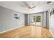 Bright bedroom features hardwood floors, ceiling fan, and glass sliding doors to the patio at 6552 River Rd, New Port Richey, FL 34652