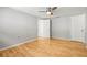 Bright bedroom with hardwood floors, ceiling fan, and ample closet space at 6552 River Rd, New Port Richey, FL 34652