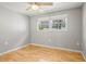 Cozy bedroom featuring a bright window with natural light and hardwood floors at 6552 River Rd, New Port Richey, FL 34652