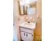 Simple bathroom vanity with storage, a round sink, and tiled walls at 6710 Hickorywood Ln # 1B, New Port Richey, FL 34653