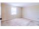 Spacious bedroom with neutral walls, plush carpet, and natural light at 6710 Hickorywood Ln # 1B, New Port Richey, FL 34653