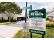 Community sign for 'The Wilds' Condominiums, a 55+ community with rules and regulations at 6710 Hickorywood Ln # 1B, New Port Richey, FL 34653