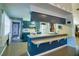 Bright kitchen features blue cabinets, white appliances, and a breakfast bar for casual dining at 6710 Hickorywood Ln # 1B, New Port Richey, FL 34653