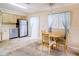 Cozy eat-in kitchen featuring stainless steel refrigerator, wood table, and natural light at 6710 Hickorywood Ln # 1B, New Port Richey, FL 34653
