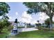 Scenic view of the community pond featuring a charming lighthouse statue and fountain at 6710 Hickorywood Ln # 1B, New Port Richey, FL 34653