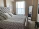 Comfortable bedroom features a tufted headboard, soft pillows, a decorative mirror, and natural light at 700 S Harbour Island Blvd # 413, Tampa, FL 33602