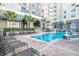 Exterior features a luxurious community pool with lounge chairs and meticulously manicured landscaping at 700 S Harbour Island Blvd # 413, Tampa, FL 33602