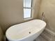 Modern soaker tub beside frosted glass window at 7026 Whitethorn Ct, Port Richey, FL 34668
