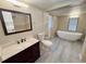 Bathroom features updated vanity, fixtures, and a large soaking tub at 7026 Whitethorn Ct, Port Richey, FL 34668