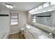 Bright bathroom features double vanity, granite countertop, and decorative tiling at 7026 Whitethorn Ct, Port Richey, FL 34668